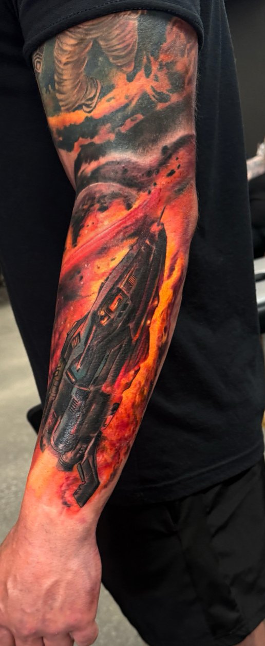 Color sci-fi spaceship and fire sleeve tattoo by Bubba Irwin, Scottsdale artist