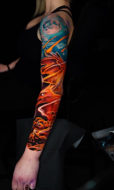 Cosmic full color sleeve tattoo with moon and flower by Bubba Irwin