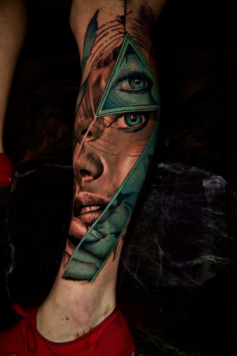 Surreal portrait leg tattoo with turquoise triangle by Bubba Irwin, color realism