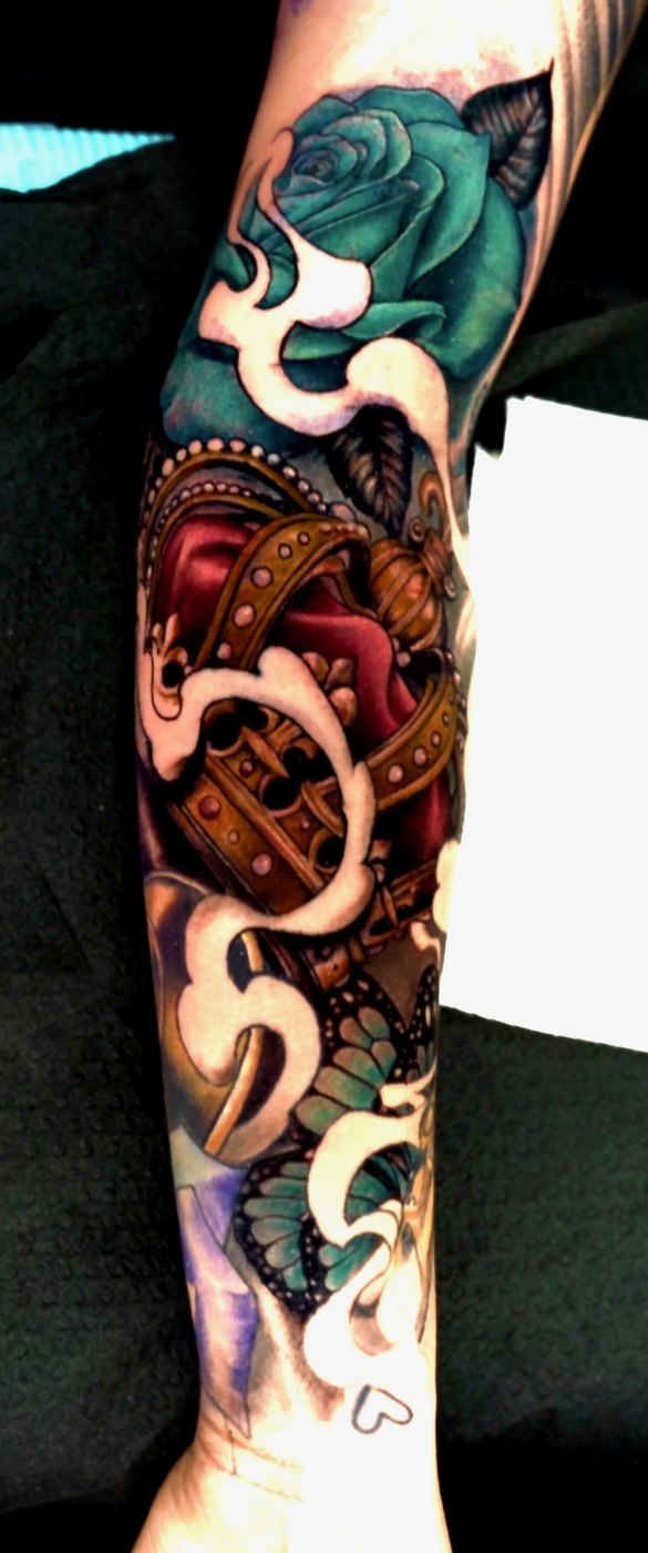 Crown and teal rose neo-traditional sleeve tattoo by Bubba Irwin, color realism artist