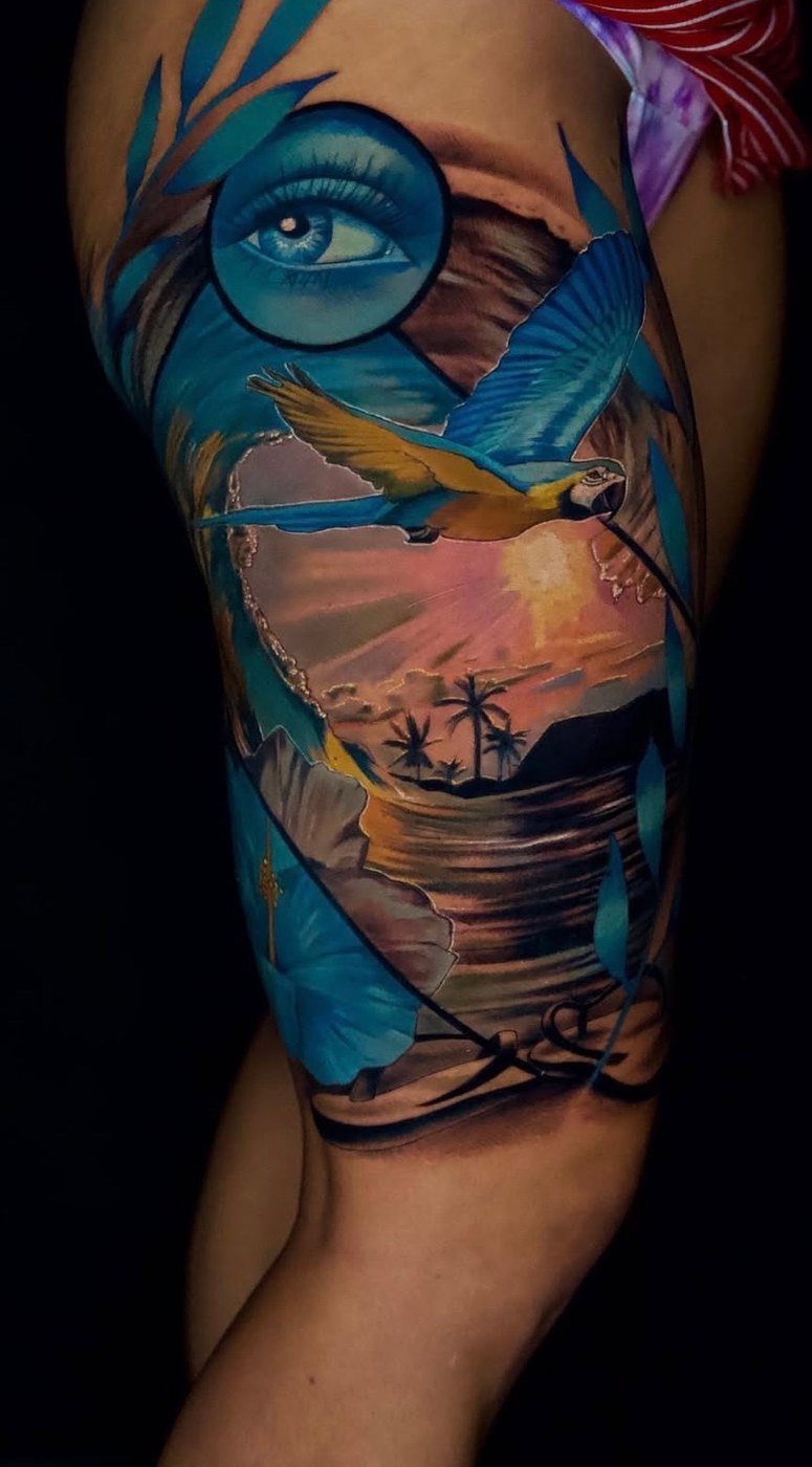 Tropical macaw sunset blue eye thigh tattoo by Bubba Irwin, color realism artist