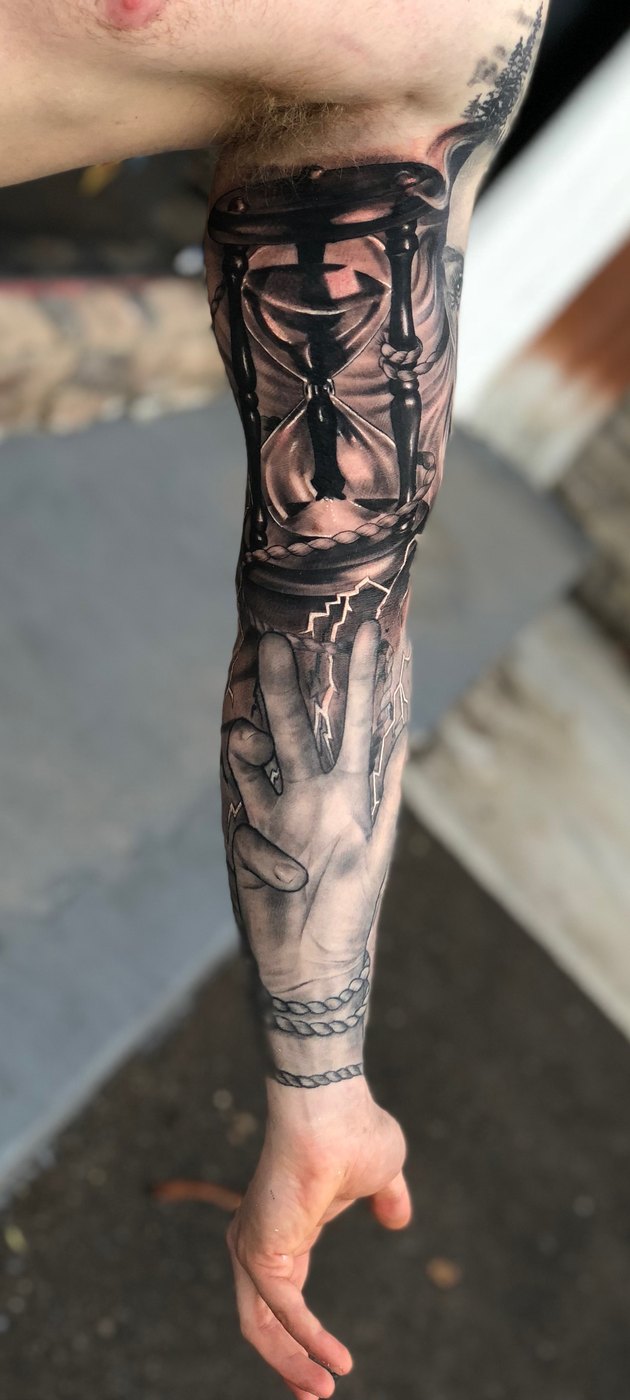 Hourglass and hand black and grey full sleeve tattoo by Bubba Irwin, realism artist Arizona